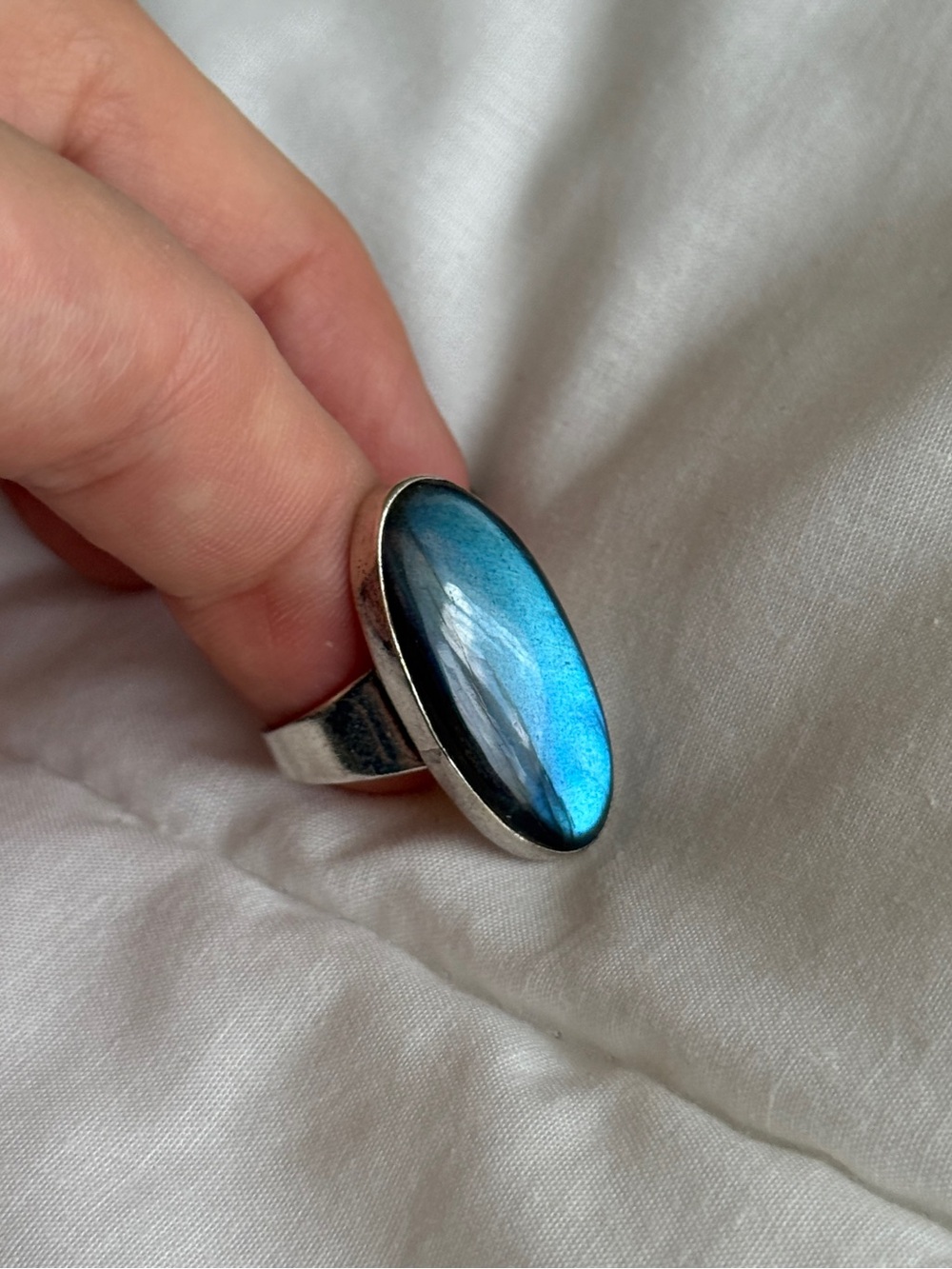 gorgeous silver ring with iridescent blue oval gemstone